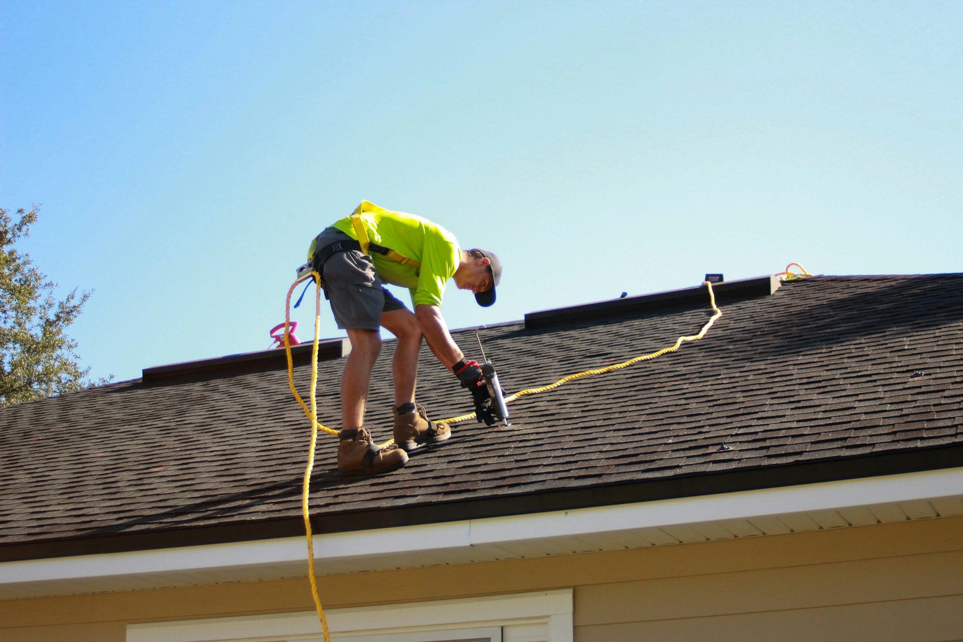 A roofing crew member at work