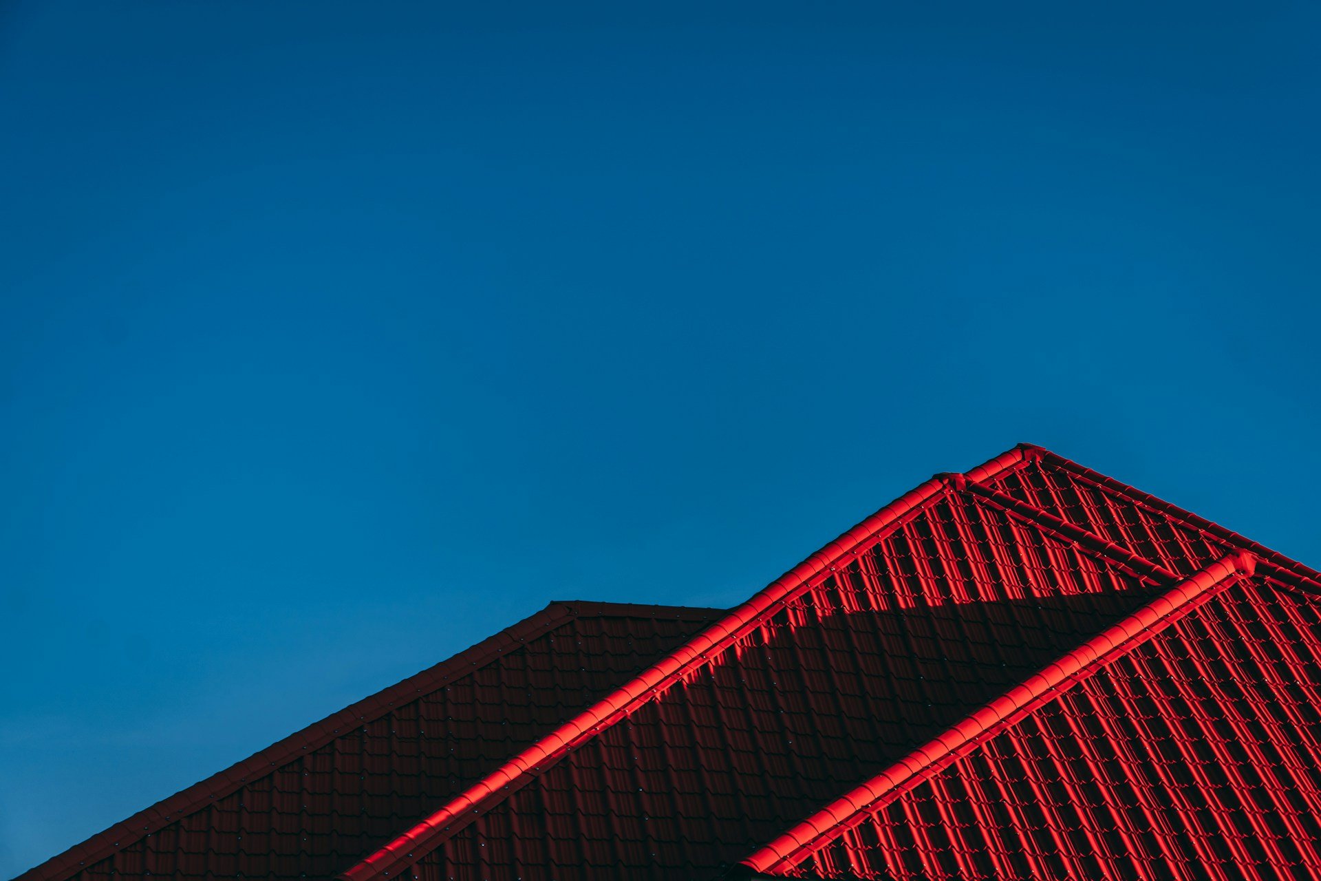 A roofline against a dramatic sky