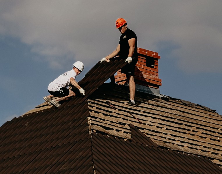 Roofing crew installing tile on a home